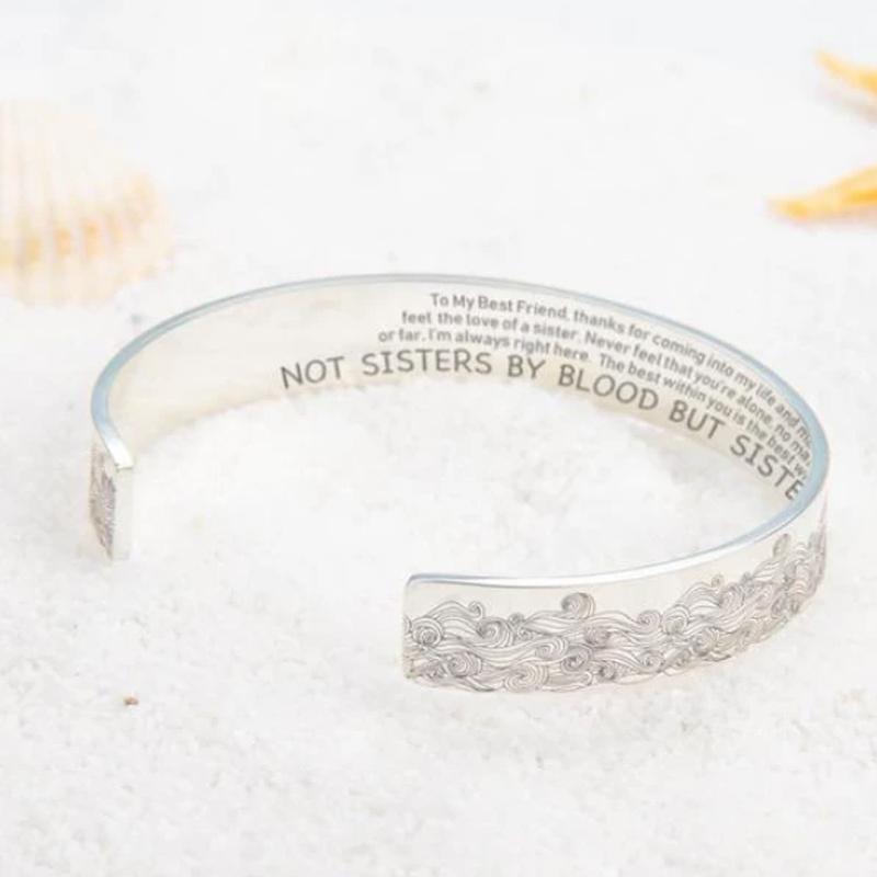 Hand modeling a stainless steel open wave bracelet, elegant and shiny