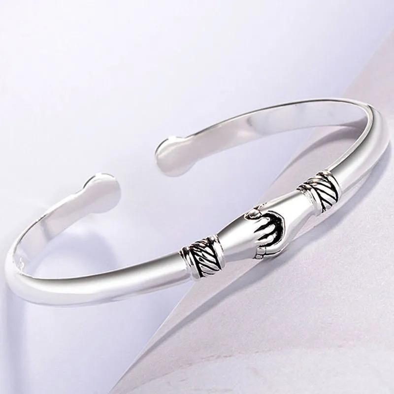 Delicate sterling silver handshake bracelet, a meaningful piece of hypoallergenic jewelry