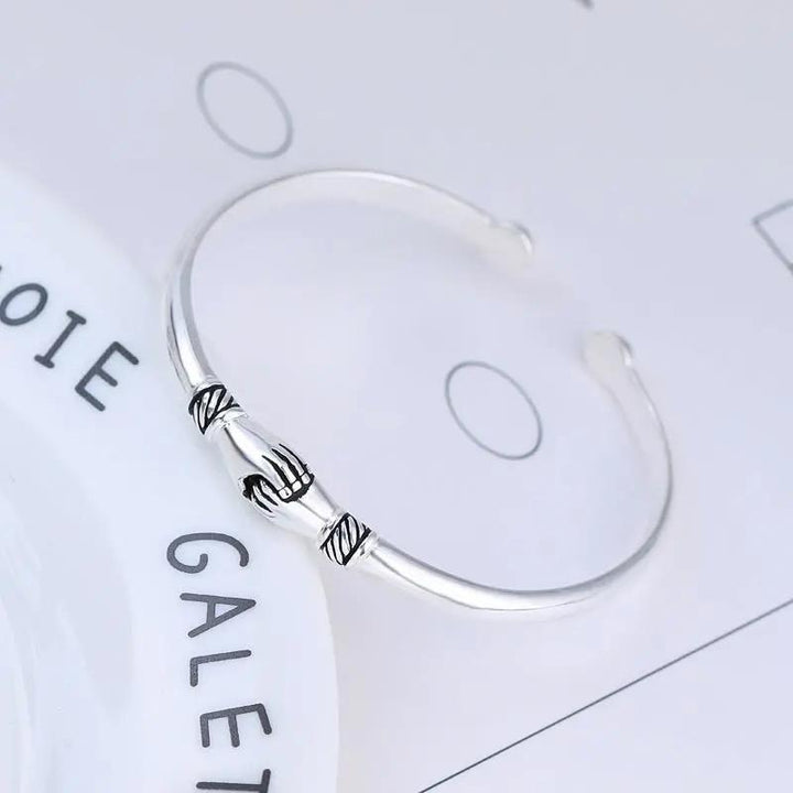 Side view of the sterling silver handshake bracelet, highlighting its sleek design