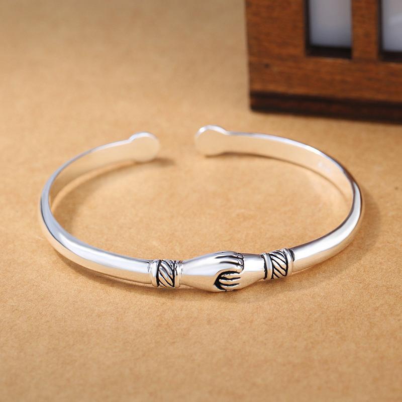 Elegant sterling silver handshake bracelet on a white background, a meaningful gift for her