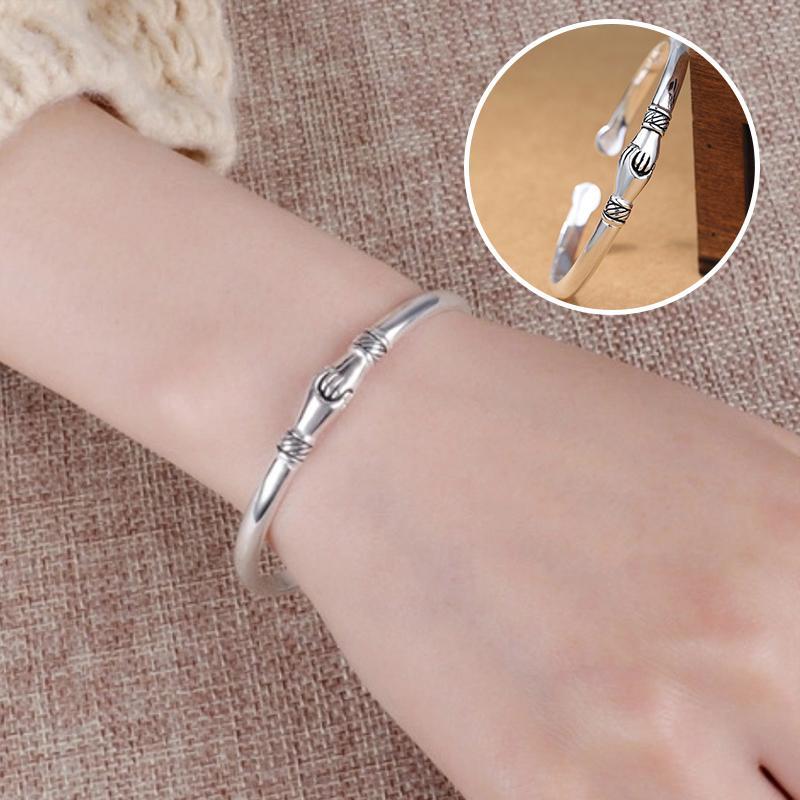 Adjustable women's sterling silver bracelet, featuring a symbolic handshake charm