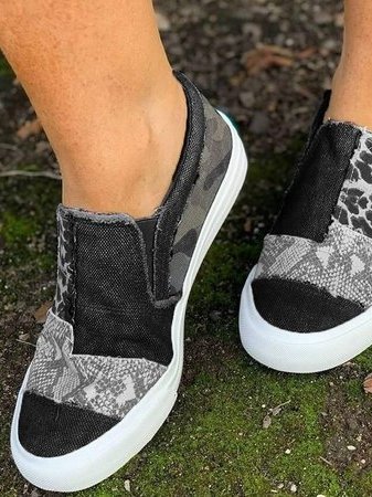 Close-up of women's leopard print slip-on shoes, showing stretch canvas texture
