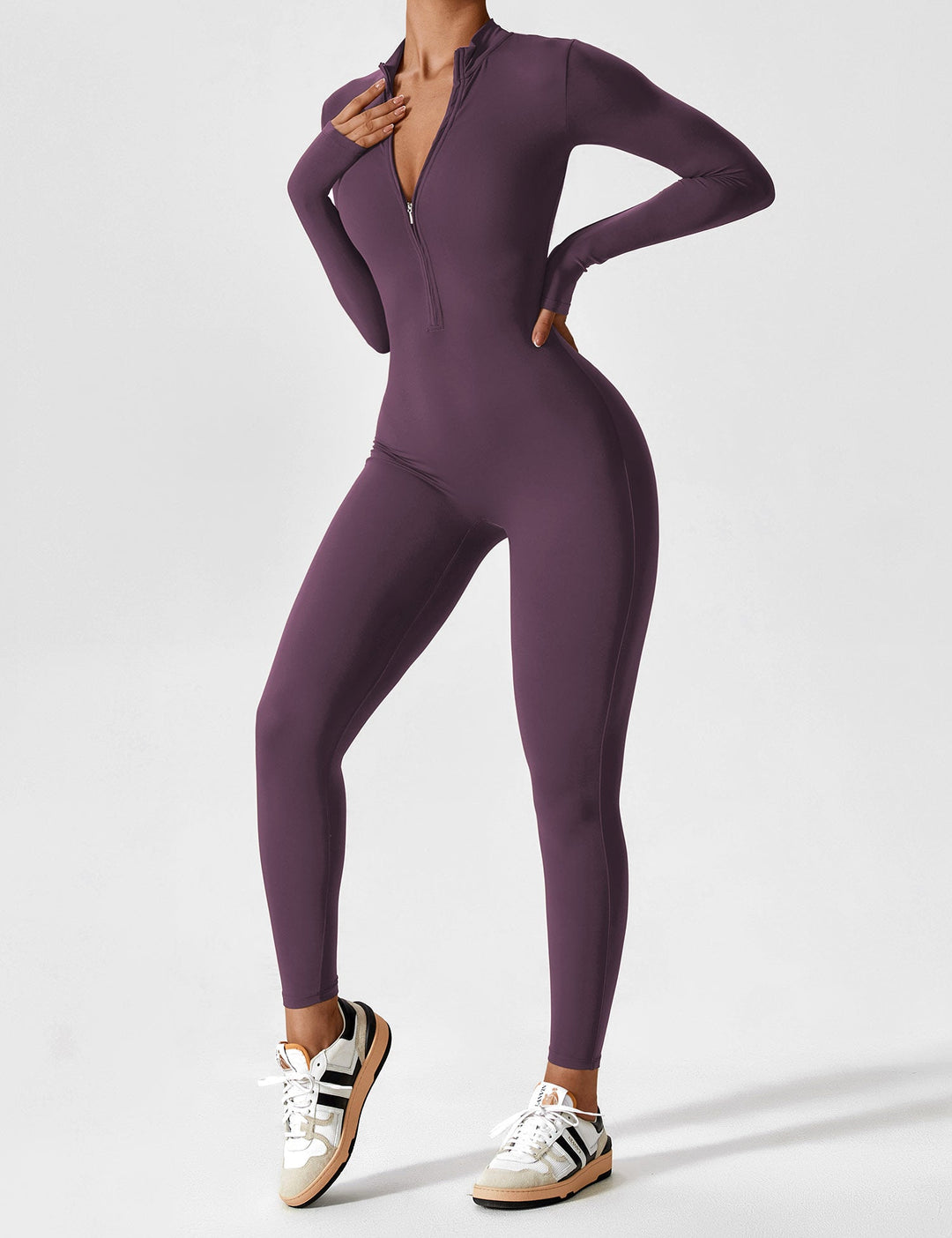 Stretchy women's jumpsuit in a soft grey, featuring a zip-up front for understated spring elegance