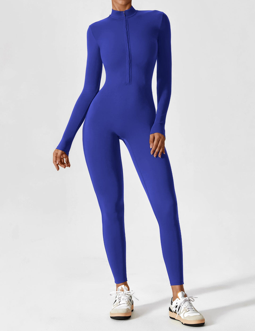 Full-body shot of a woman modeling a versatile stretchy zip-up jumpsuit, perfect for spring fashion