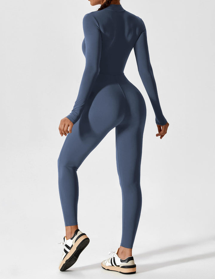Woman in a relaxed pose wearing a comfortable stretchy zip-up jumpsuit, perfect for spring casual wear
