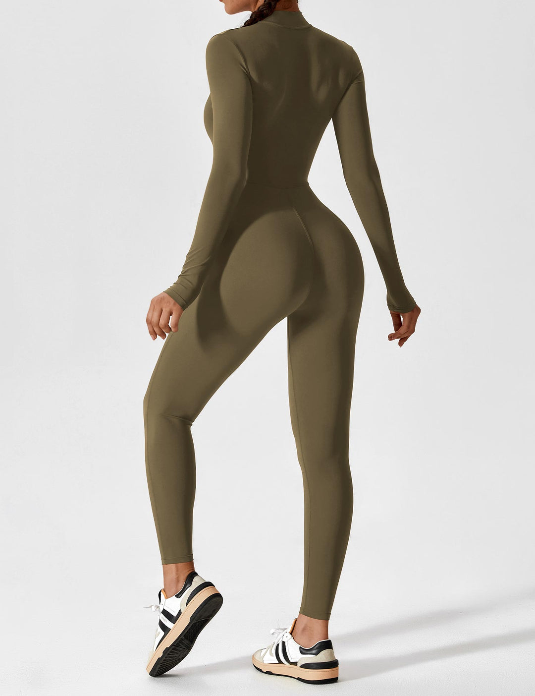 Woman posing playfully in a comfortable stretchy zip-up jumpsuit, perfect for active spring wear