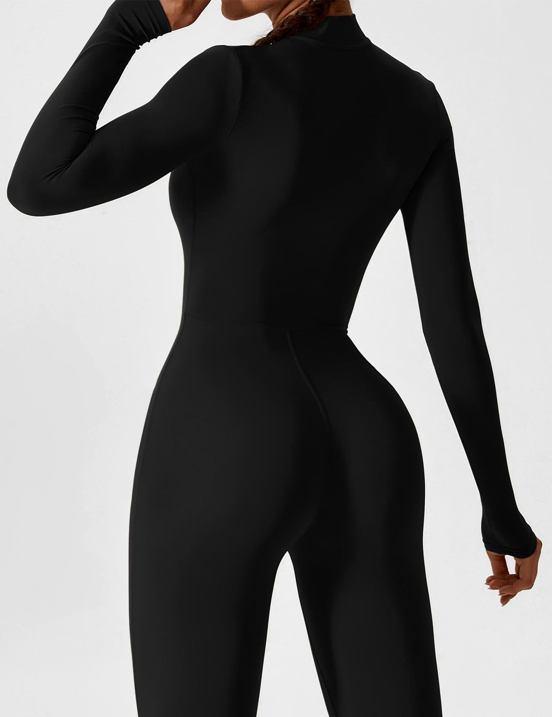 Back view of a women's one-piece stretchy jumpsuit, showcasing its effortless spring style and comfort