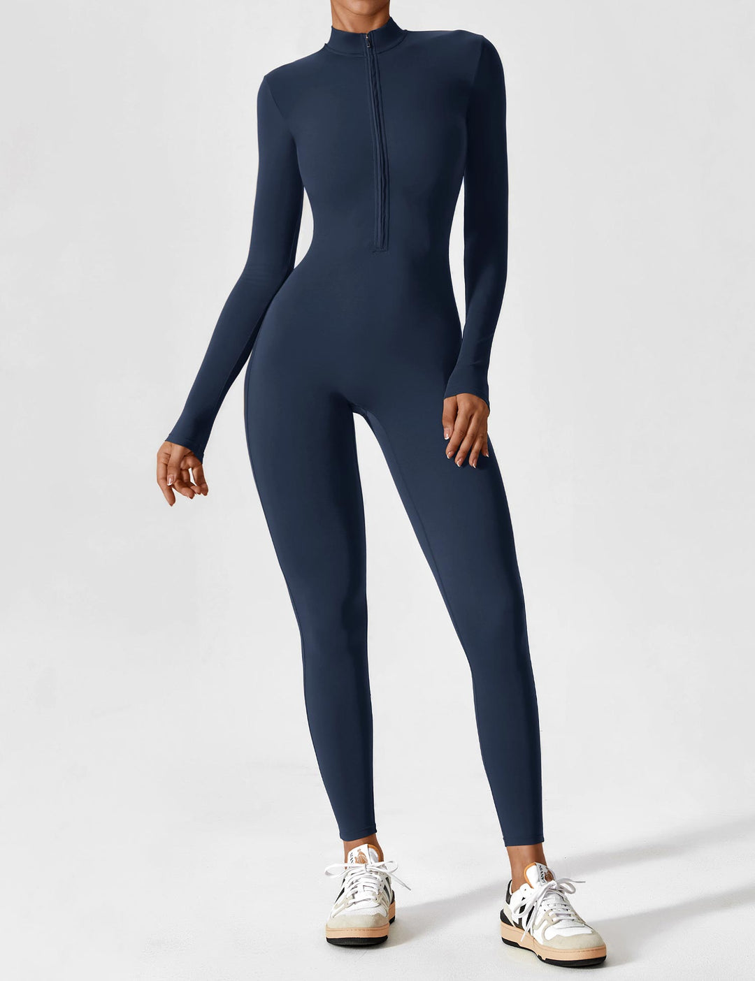 Full-length shot of a woman showcasing the versatility of a stretchy zip-up jumpsuit for spring