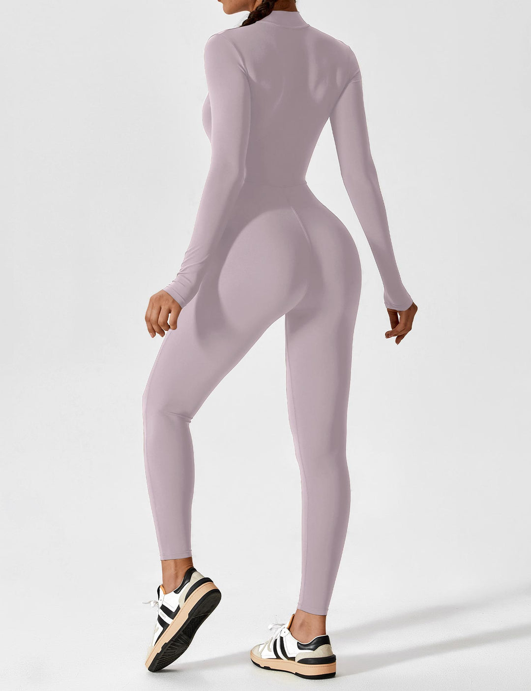 Fashionable women's stretchy jumpsuit for spring, showcasing its elegant draping and zip detail