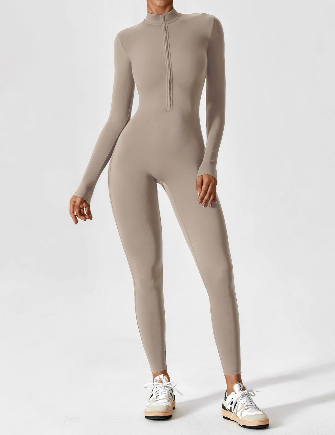 Woman smiling brightly in a comfortable stretchy zip-up jumpsuit, ready for spring activities