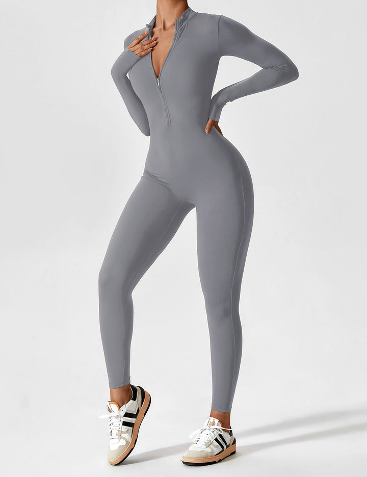 Woman reaching out in a comfortable stretchy zip-up jumpsuit, flexibility for spring movements