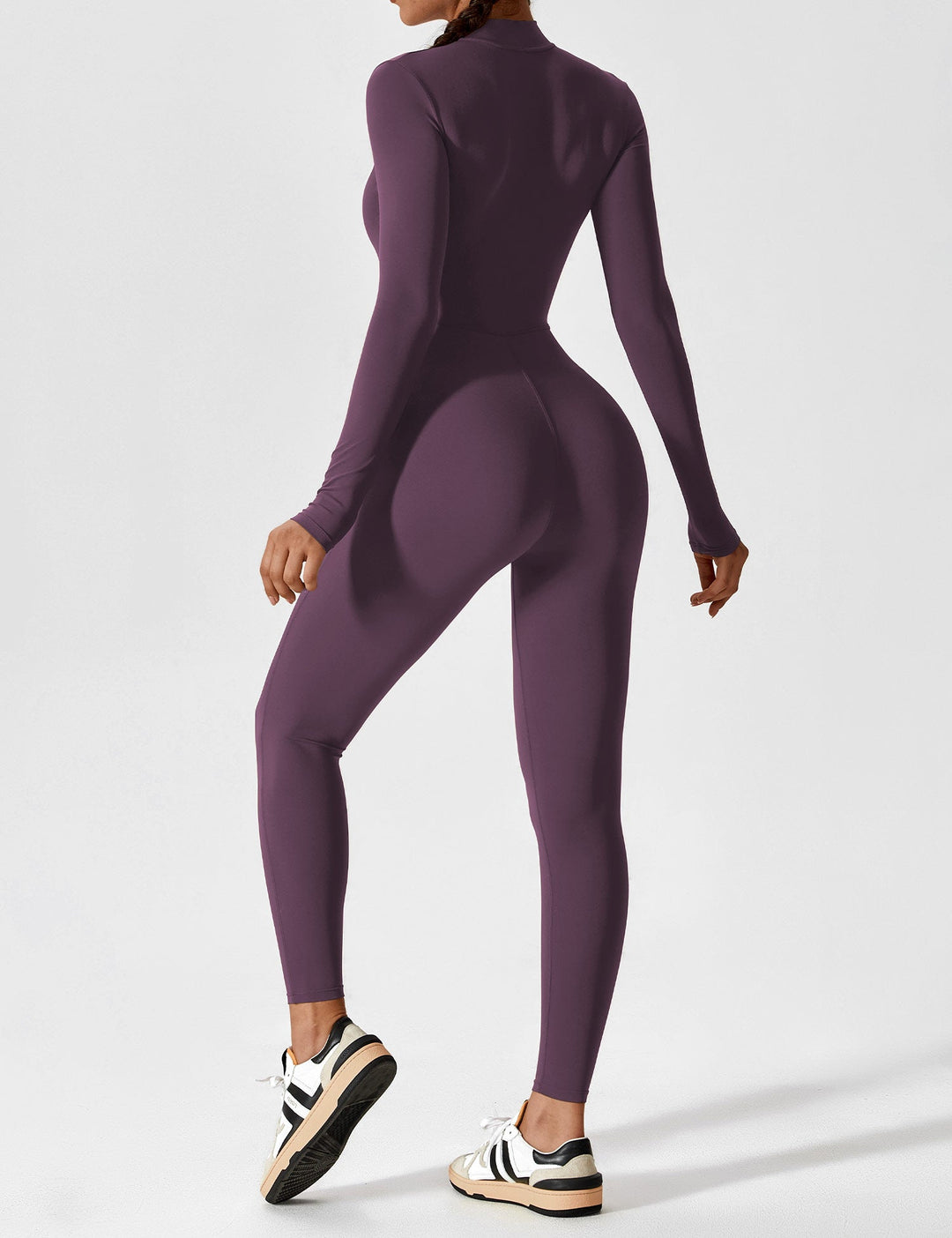 Woman posing with hands in pockets of a comfortable stretchy zip-up jumpsuit, casual spring style