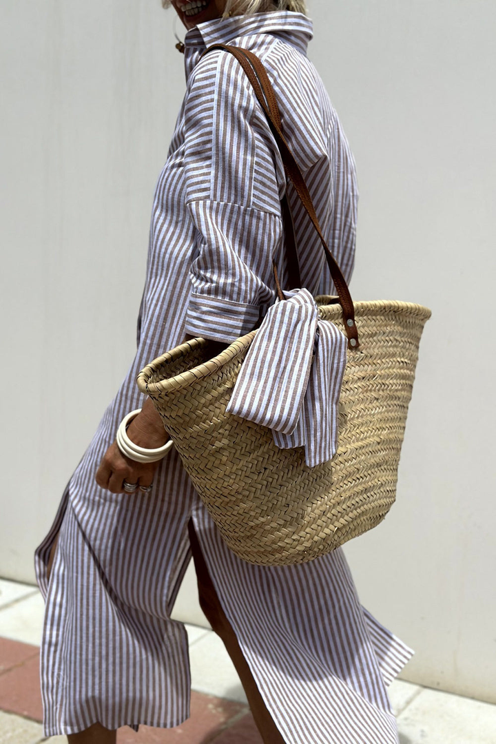 Chic women's striped collared button-down midi dress, ideal resort wear or stylish summer beach outfit.