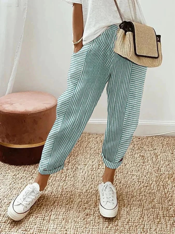 Stylish women's cropped pants featuring classic stripes and practical side pockets. Straight leg, pull-on style for easy wear.