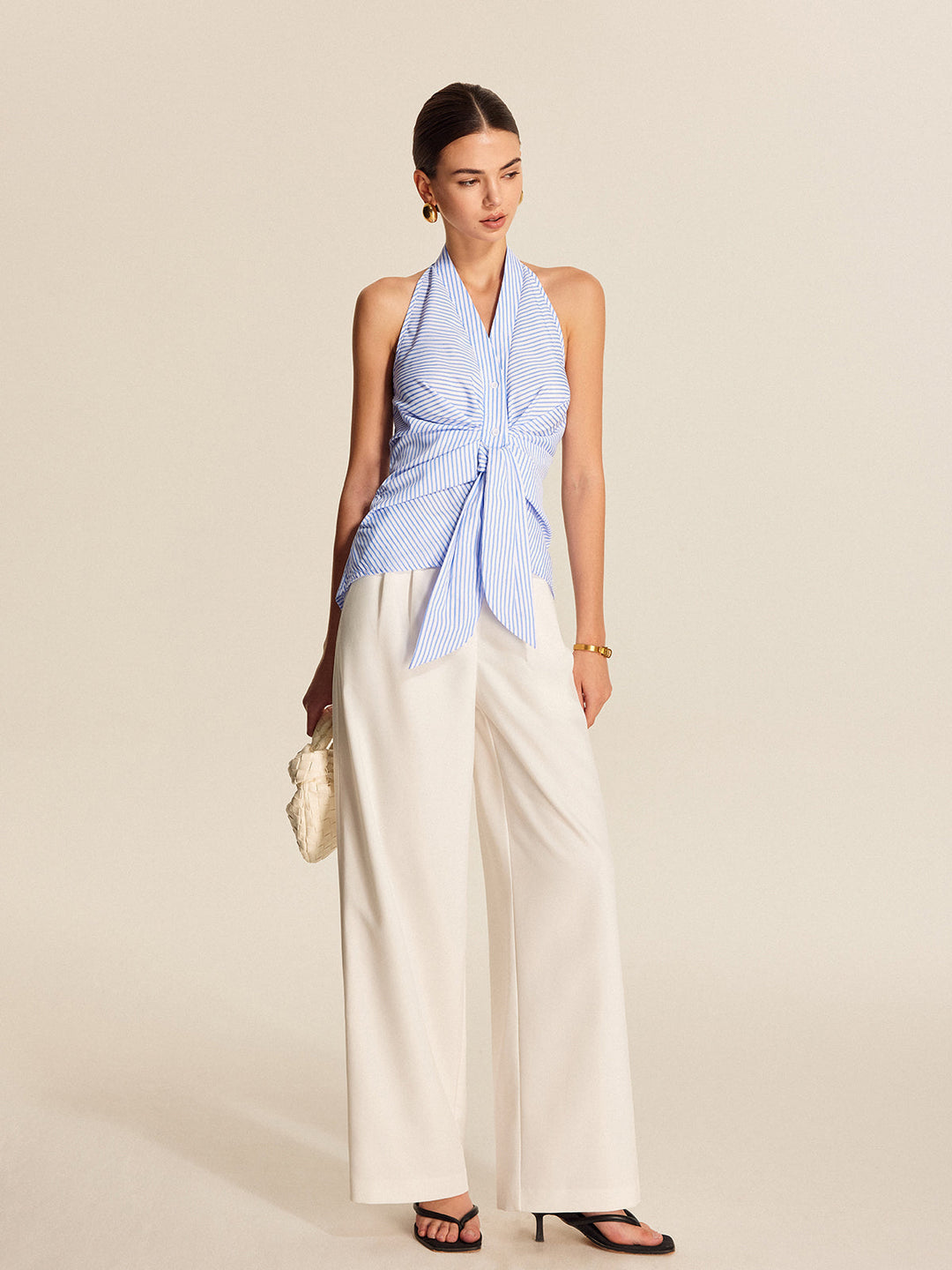 Elegant women's striped halter blouse with a stylish tie-front. Ideal for office style or a chic summer look.
