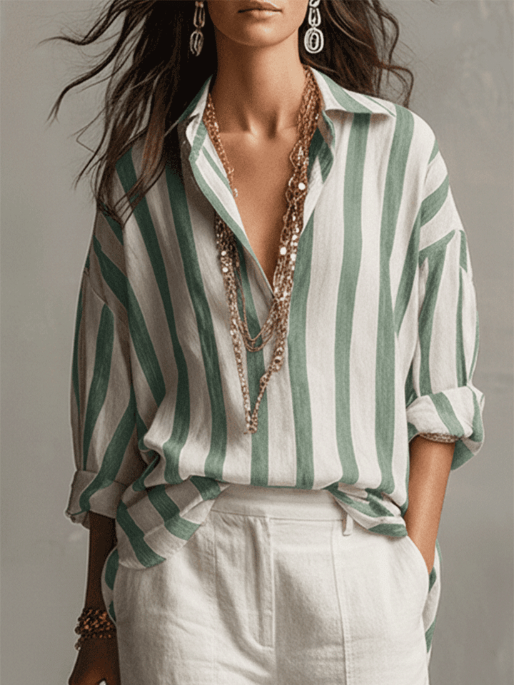 Relaxed fit women's striped long sleeve blouse. Features a classic button front, ideal for comfortable daily fashion.