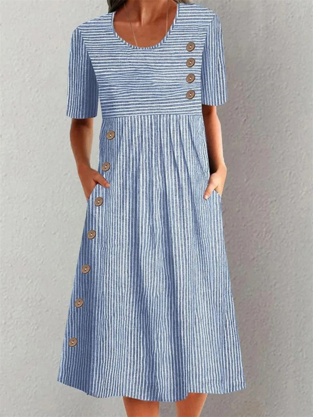 Women's striped midi dress with button details. Perfect for casual summer wear, everyday style, or workwear.