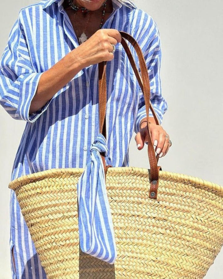 Stylish women's pink striped shirt dress, midi cut. With front button closure & functional side pockets. Casual day fashion.