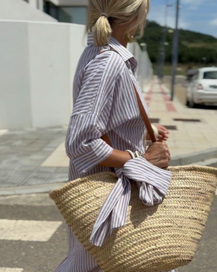 Classic women's striped midi shirt dress. Features button-front closure & convenient pockets. Great for casual or elegant looks.