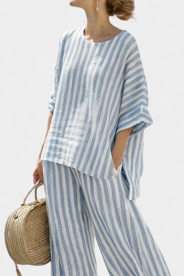 Relaxed fit women's two-piece striped set featuring a batwing top & wide-leg pants, ideal for vacation.