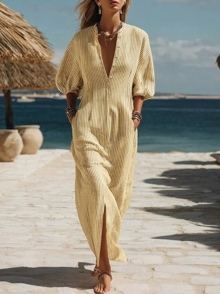 Elegant women's striped V-neck dress, a flowy maxi with puff sleeves and full buttons.