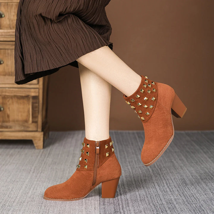 Textured close-up of the studded collar on women's fashion ankle boots. High-quality design.