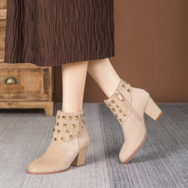 Back view of women's studded block heel ankle boots. Durable and stylish for all-day comfort.