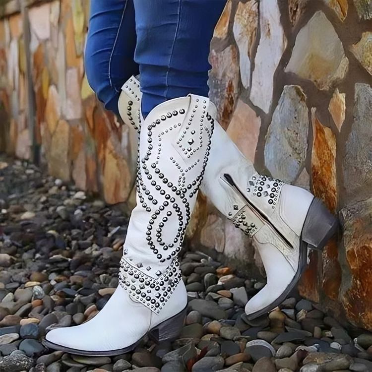 Bold women's studded knee-high western boots, featuring a pointed toe and chunky block heel for impactful style.