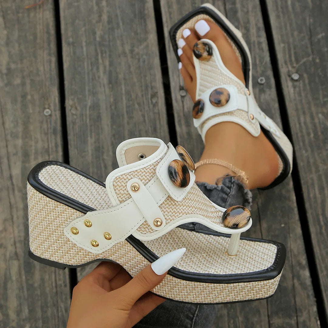 Black studded platform wedge slides for women, emphasizing the trendy studded embellishments