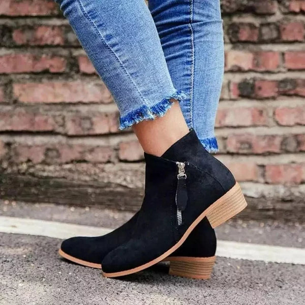 Close-up of women's trendy brown zip-up ankle boots, versatile casual dress boots