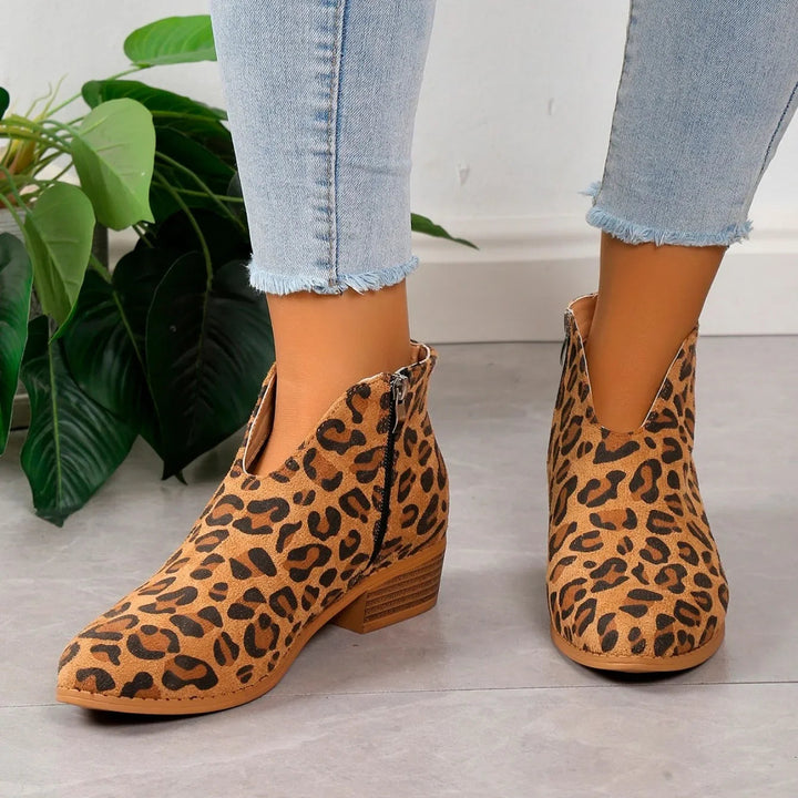 Women's stylish leopard print ankle boots with a prominent side zipper, perfect for autumn fashion.