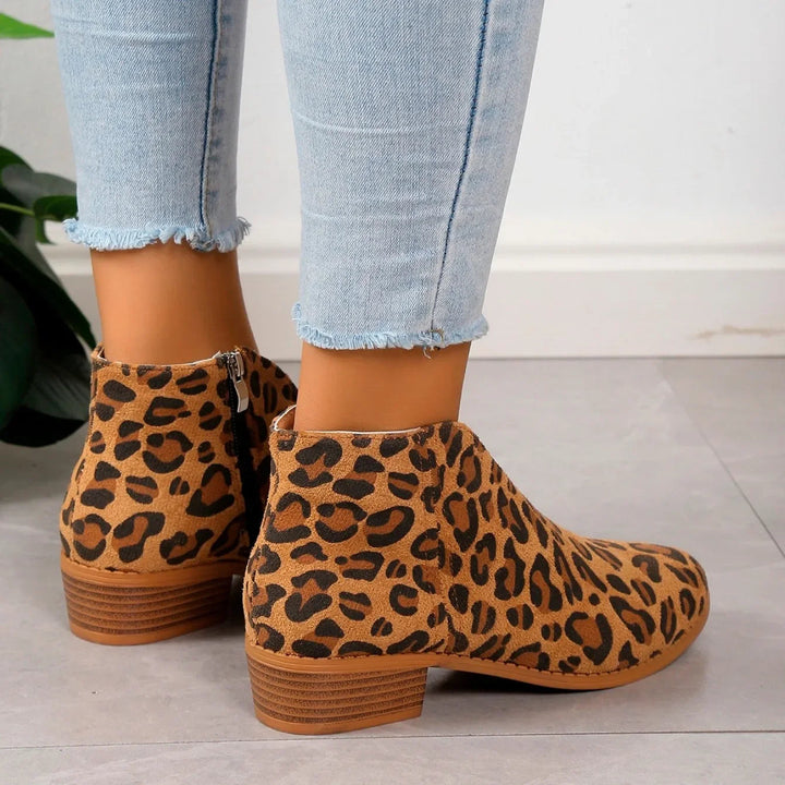 Pair of women's fashion ankle boots in a bold leopard print, featuring a practical and stylish side zipper.