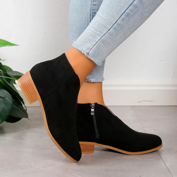 Women's animal print ankle boots with a sleek black zipper, ideal for adding a chic touch to any outfit.