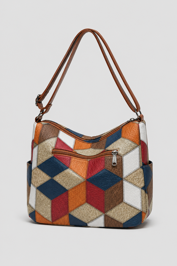 Close-up of a women's patchwork shoulder bag, highlighting its unique fabric textures & artistic design details.
