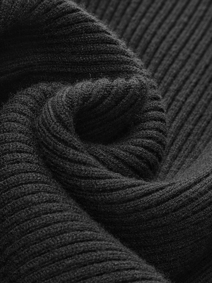 Close-up of the cuff and sleeve detailing on a women's knit ribbed turtleneck sweater.
