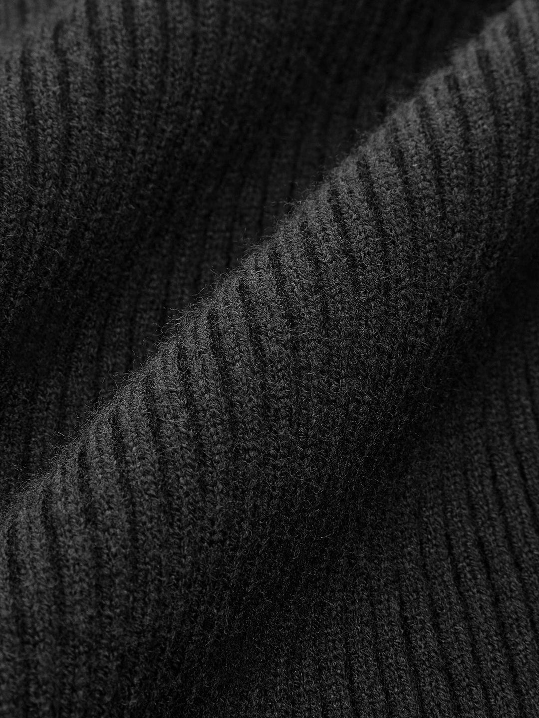 Stylish women's ribbed turtleneck sweater paired with jeans, demonstrating a casual chic outfit.