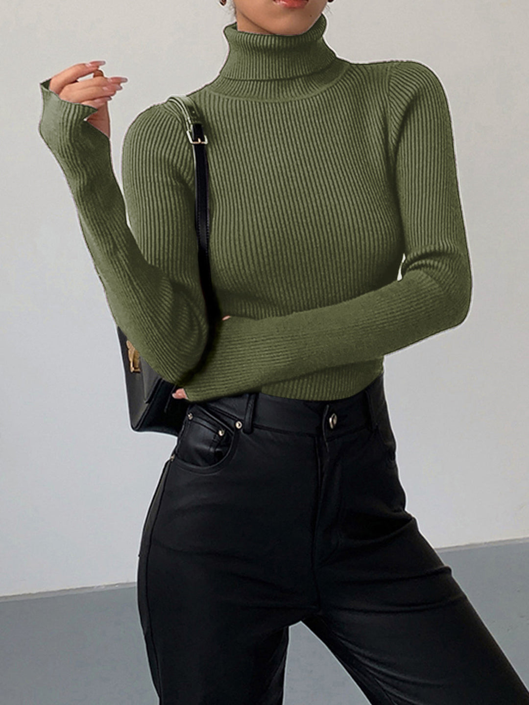 Textured women's ribbed turtleneck sweater in a neutral cream, a versatile and essential wardrobe piece.