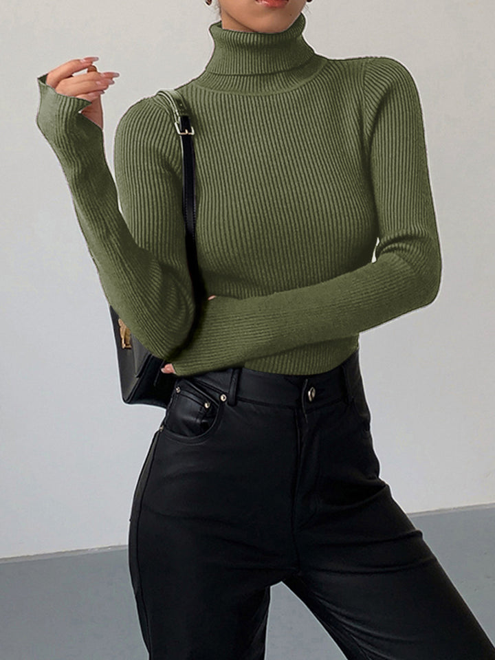 Textured women's ribbed turtleneck sweater in a neutral cream, a versatile and essential wardrobe piece.