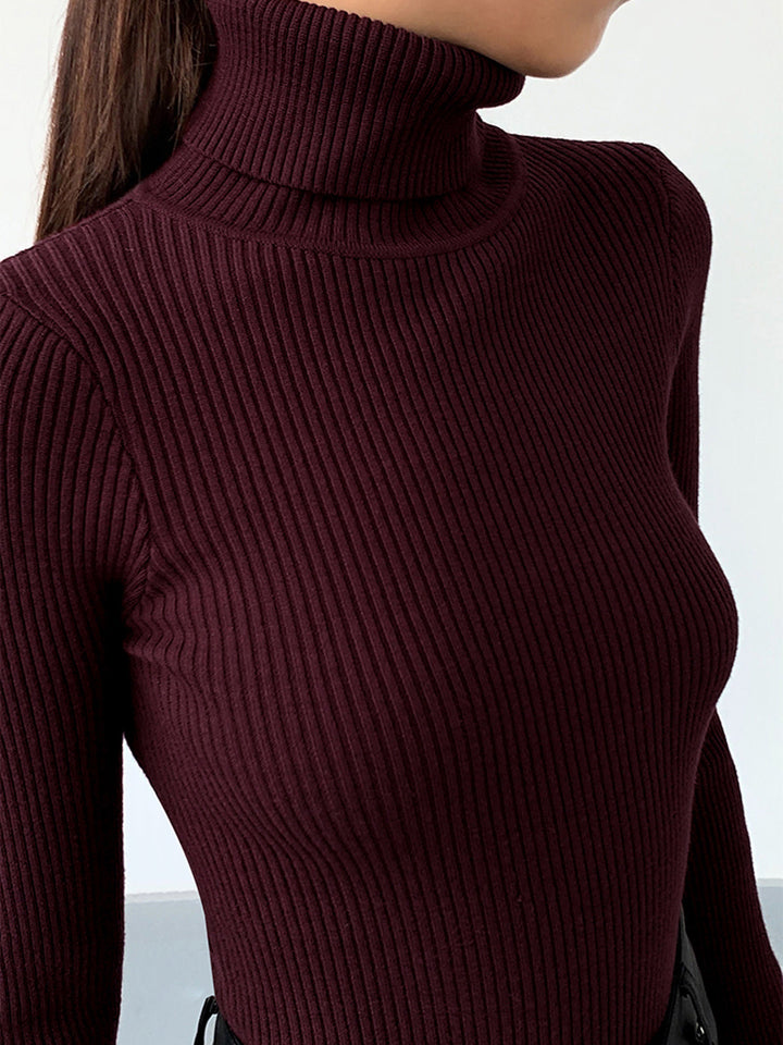 Close-up of the elegant knit pattern on a women's ribbed turtleneck pullover, showcasing its quality.