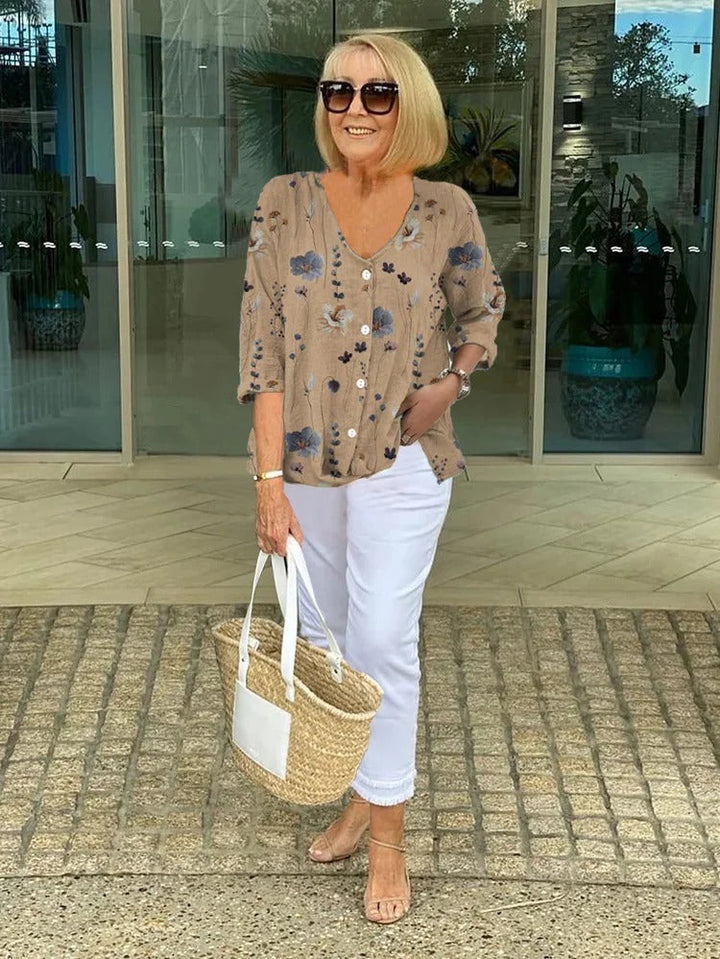 Printed women's V-neck blouse with three-quarter sleeves, a versatile button-front top for ladies fashion.