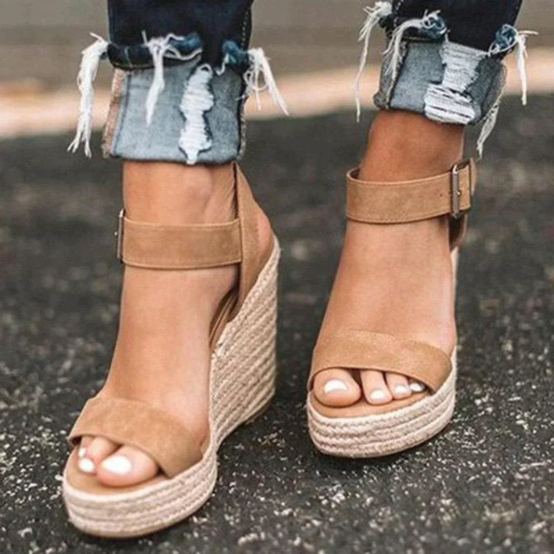 Women's stylish wedge woven sandals with adjustable buckle. Comfortable open-toe summer footwear for casual chic.