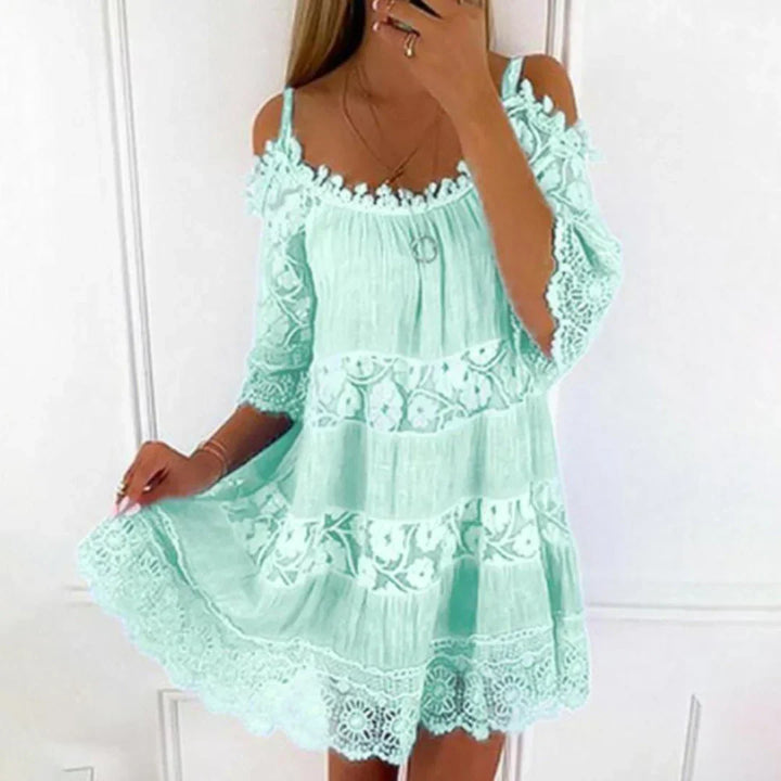 Elegant women's summer mini sundress, featuring intricate crochet lace and chic cold shoulder. Ideal for beach vacations.