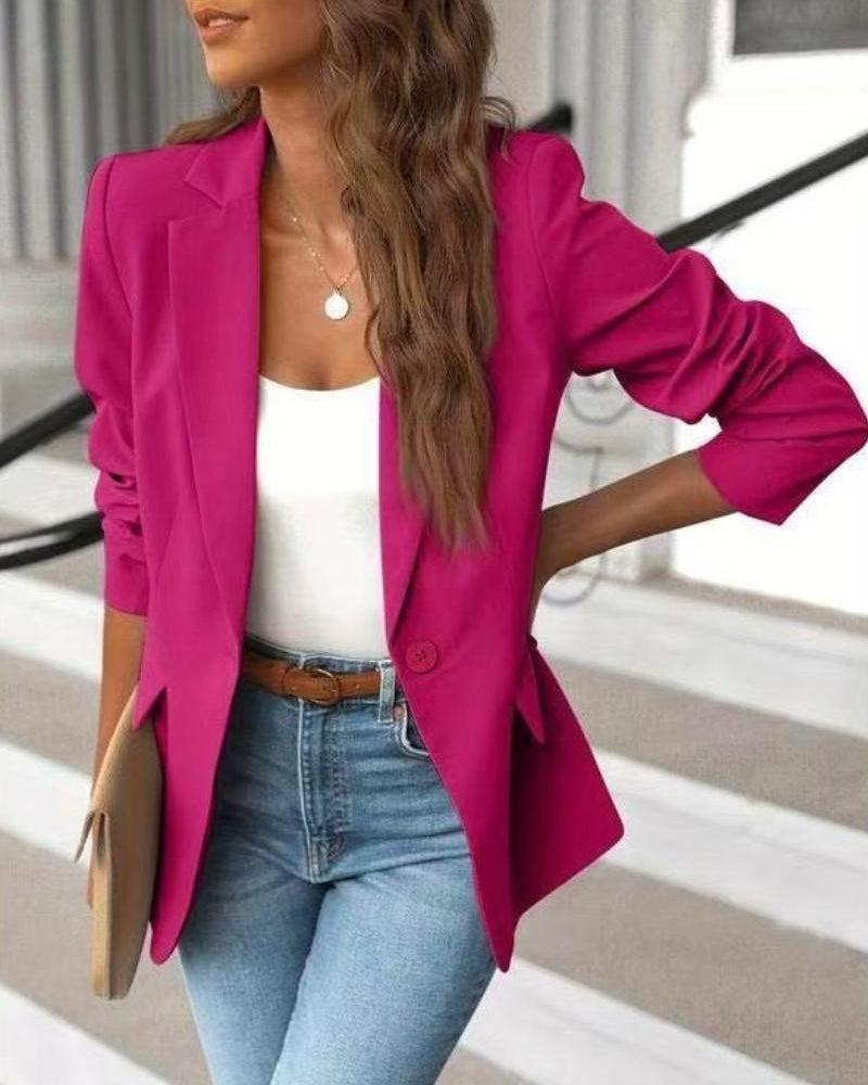 Close-up of a sophisticated women's single-button tailored jacket, highlighting the stylish ruched sleeve detail.