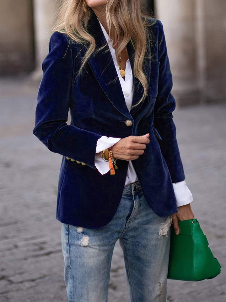 Slim-fit women's tailored velvet blazer with polished gold buttons, offering a modern and chic style.