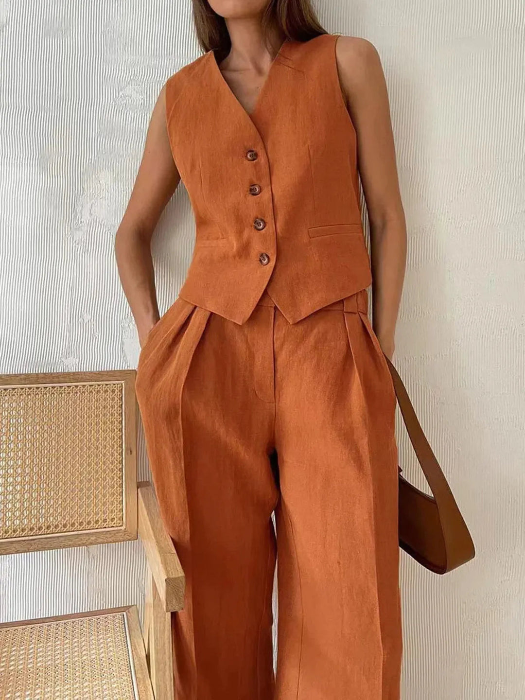 Chic women's tailored waistcoat and wide-leg trousers, a fashionable matching set for elegant wear.