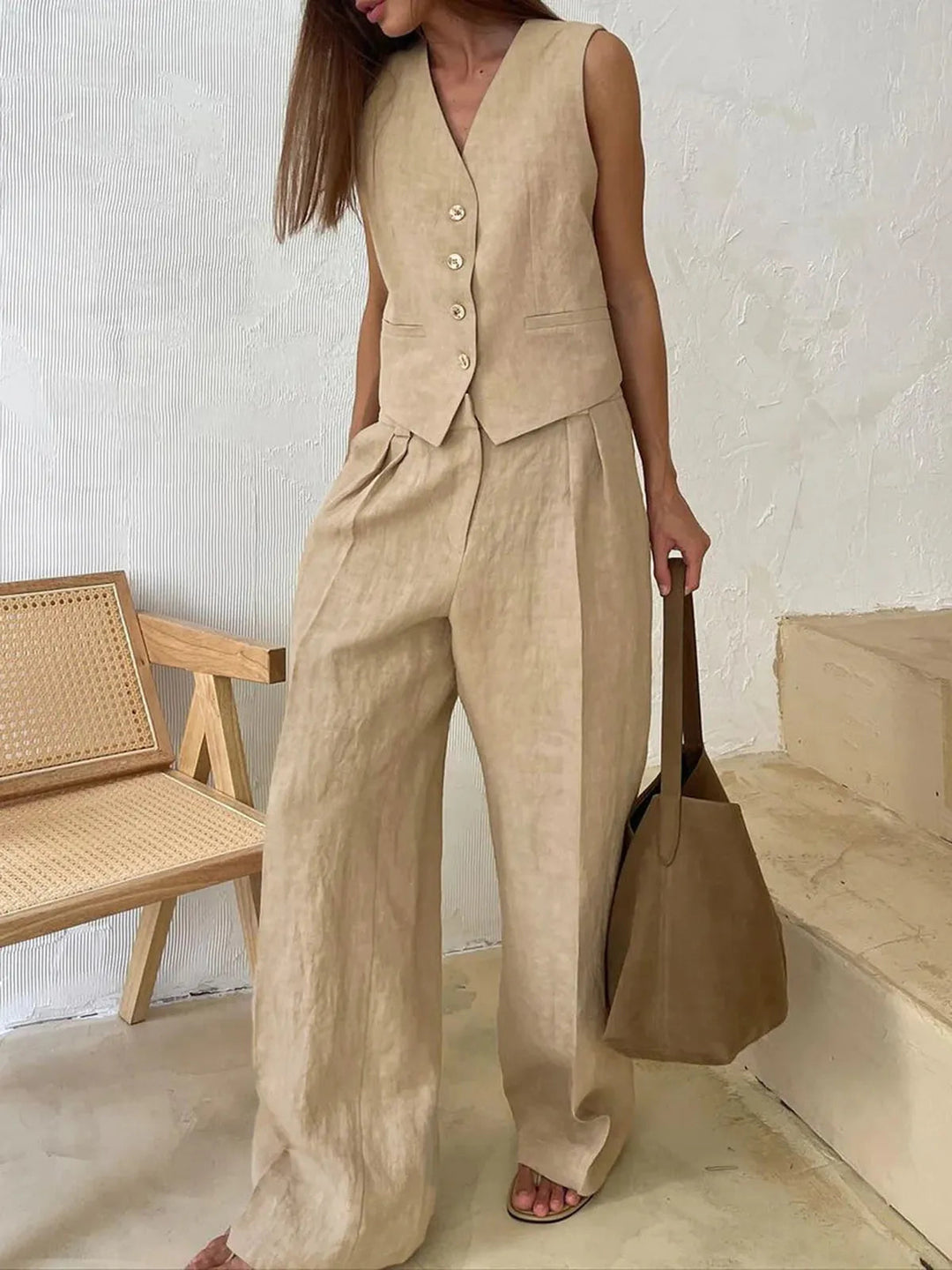 Stylish women's matching set featuring a tailored waistcoat & wide-leg pants, ideal for elegant summer events.