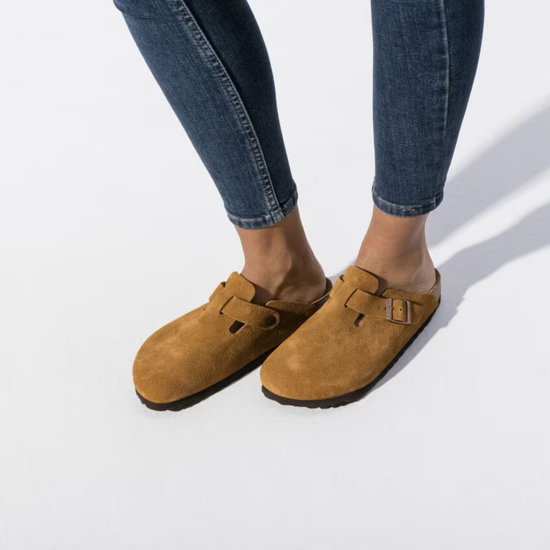 Side view of women's taupe comfort clogs, highlighting the cushioned sole and casual slip-on design.