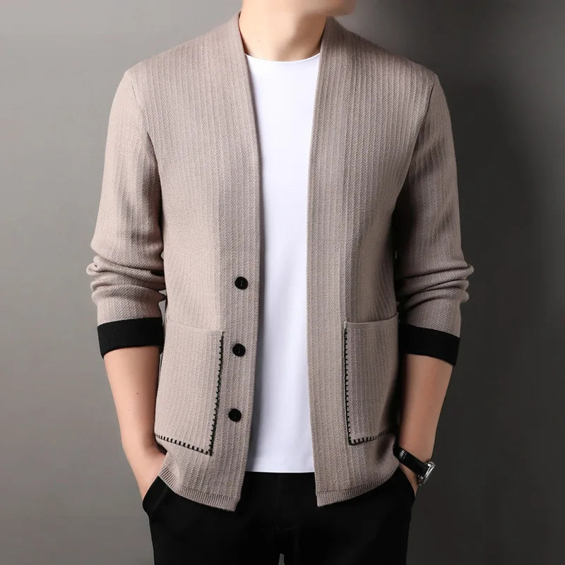 Detail of the button closure on a women's textured knit long sleeve cardigan