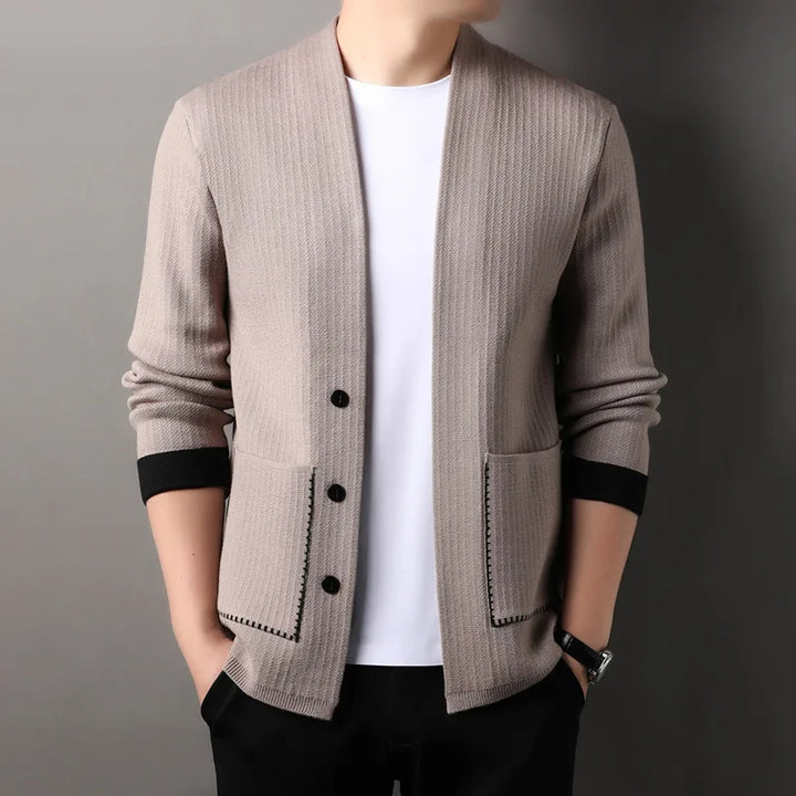 Detail of the button closure on a women's textured knit long sleeve cardigan