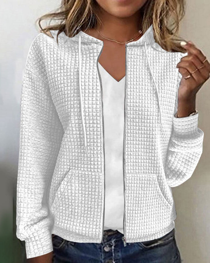 Close-up of a women's cozy textured zip-up hoodie, showcasing soft fabric, perfect for stylish everyday comfort.
